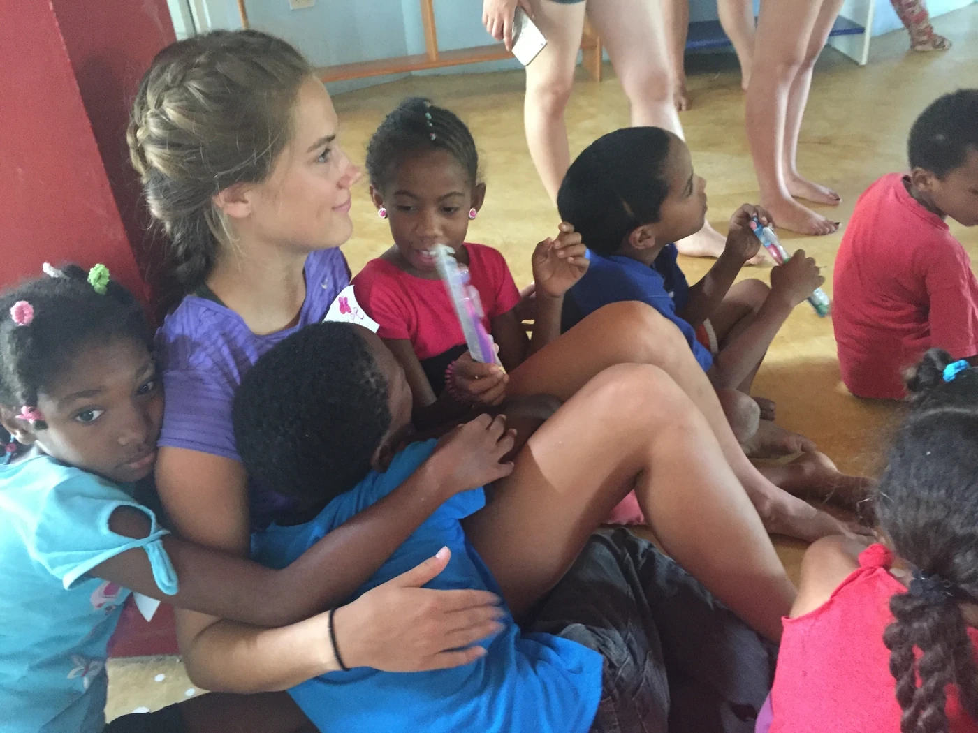 Volunteer seated with a group of children